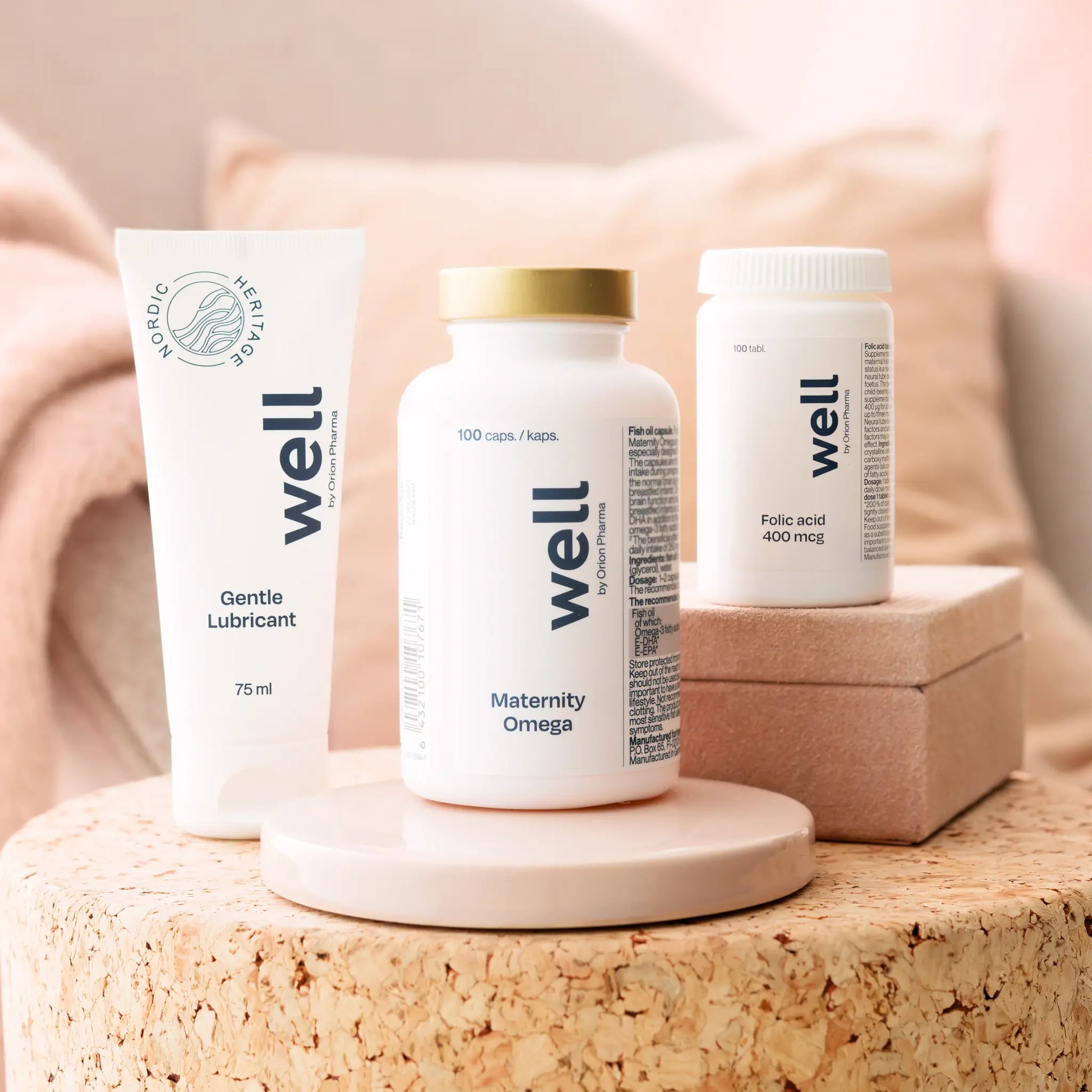 Three 'well' branded products on a cork surface with a soft, blurred background.