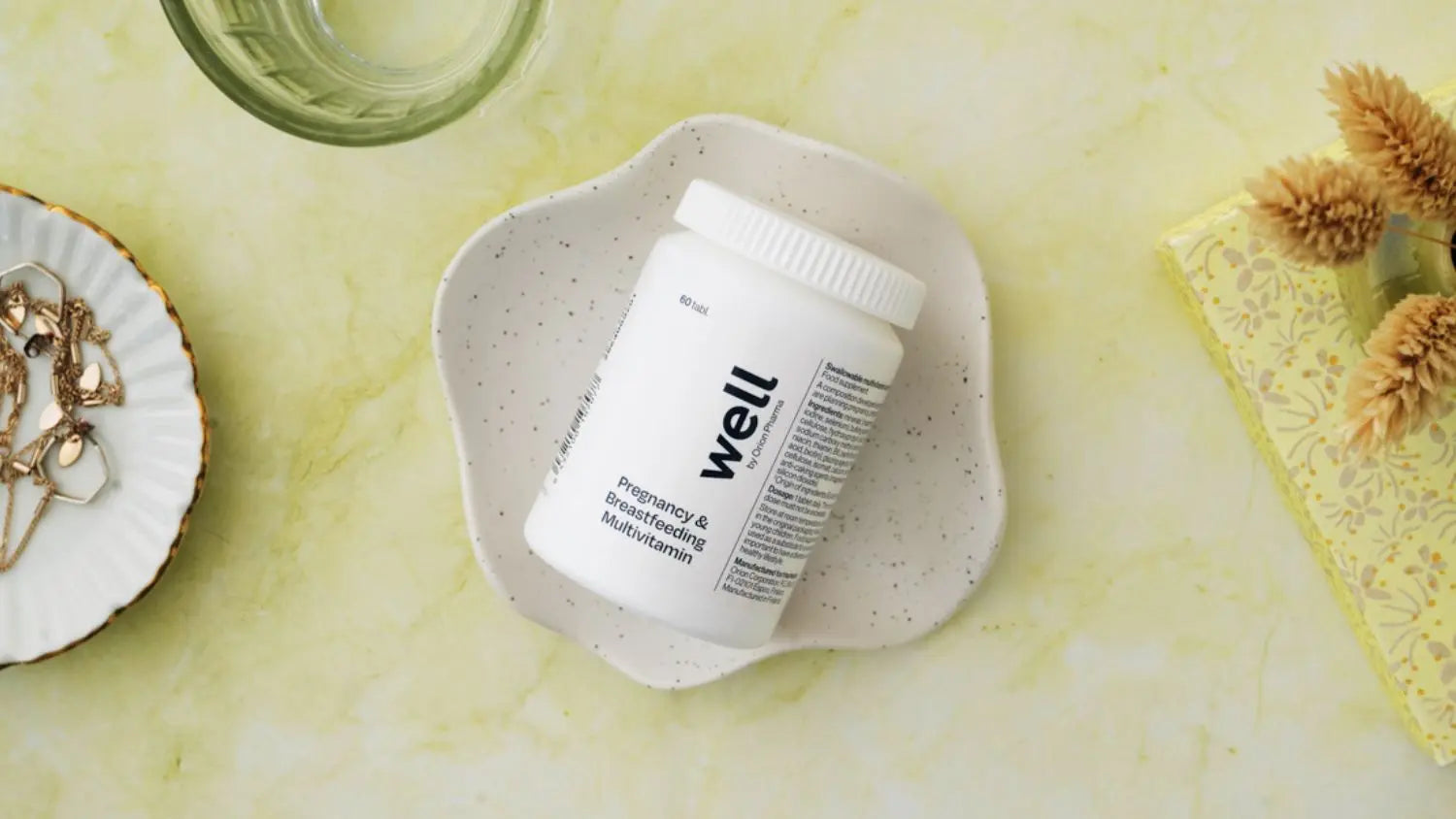 Well supplement bottle on a textured surface with decorative items