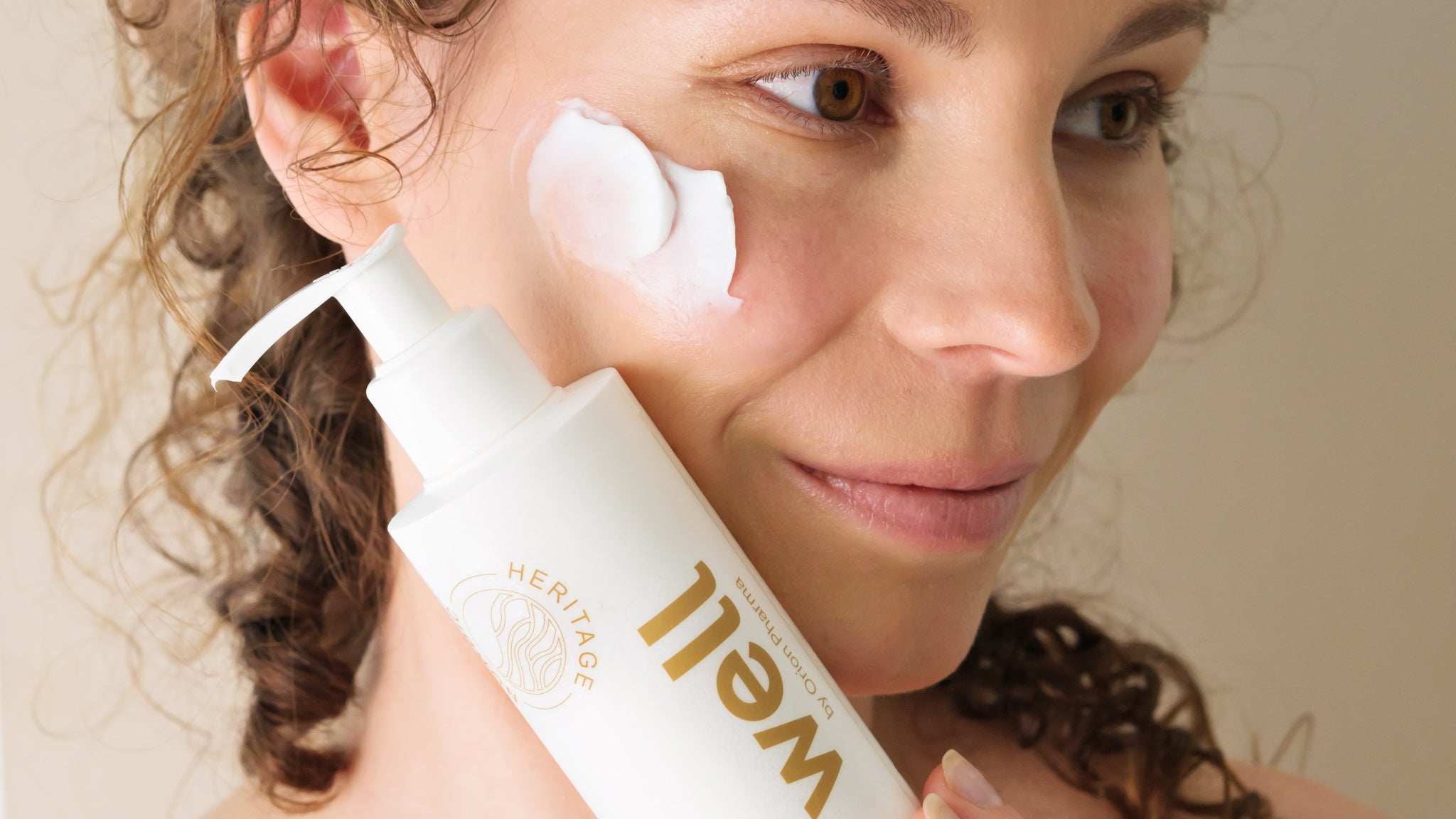 Woman with gentle cleansing and moisturizing cream
