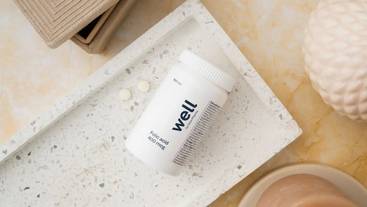 White container labeled 'well' on a textured surface with a neutral background