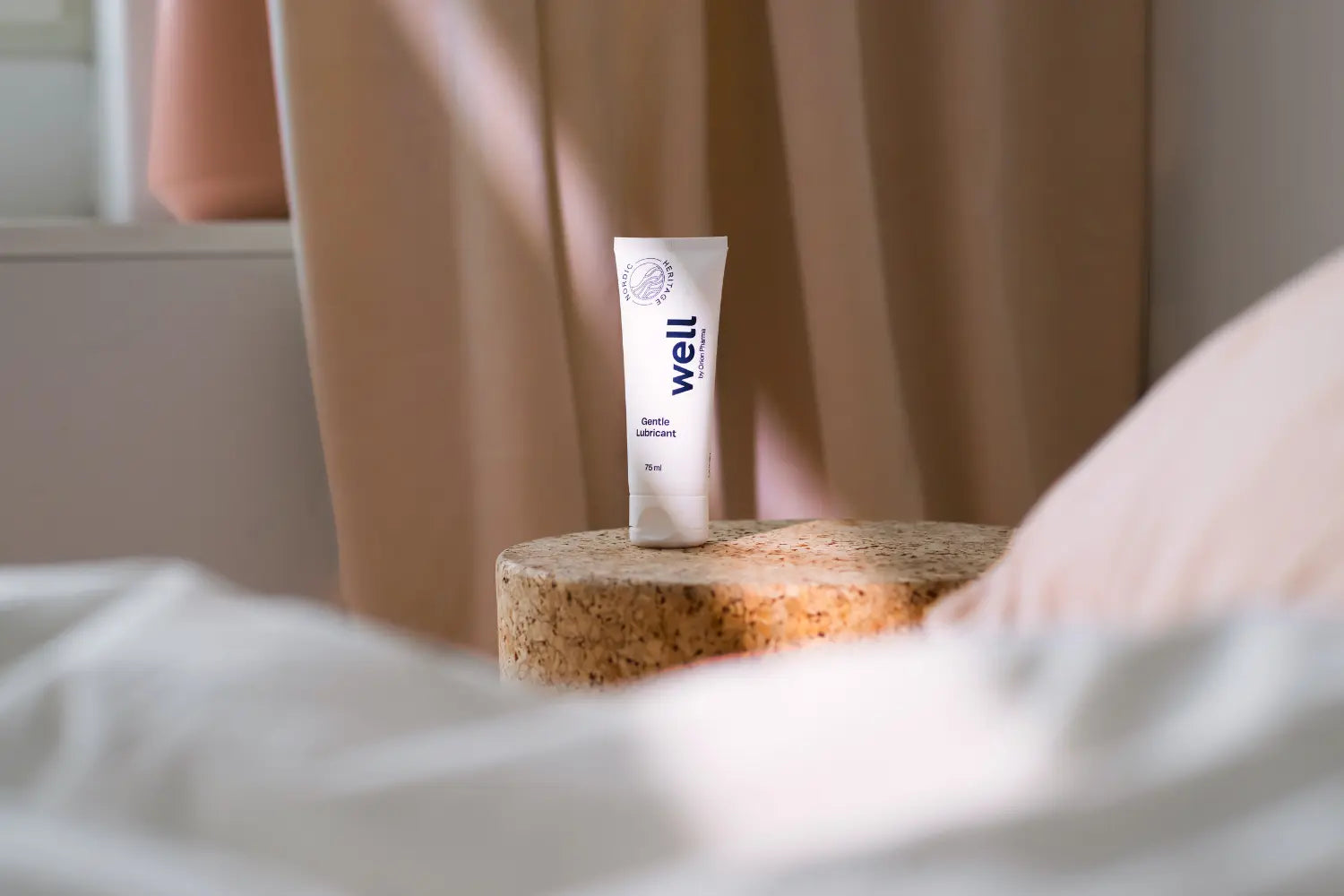 Tube of Well by Orion Pharma on a cork stand with a blurred background